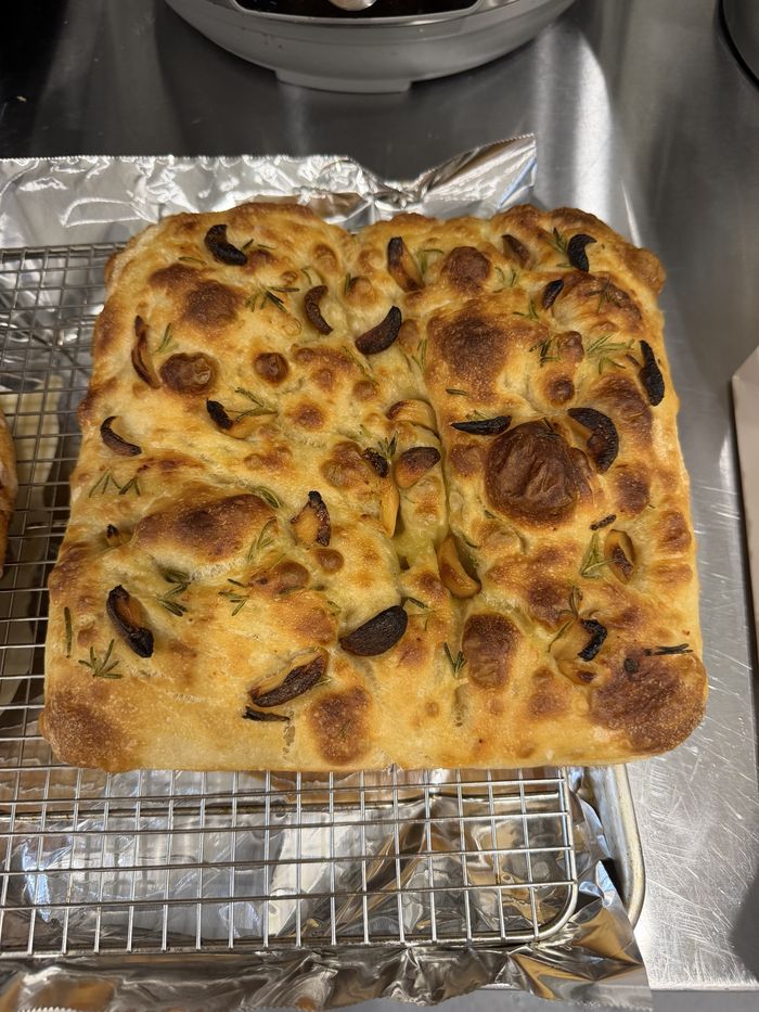 Garlic and rosemary focaccia, golden and dimpled